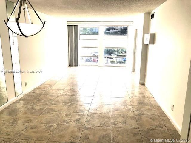 hallway with a textured ceiling