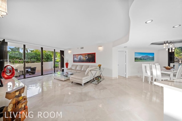 living room featuring floor to ceiling windows and a notable chandelier