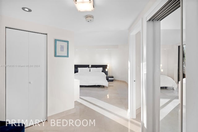 bedroom featuring a closet and light tile patterned floors