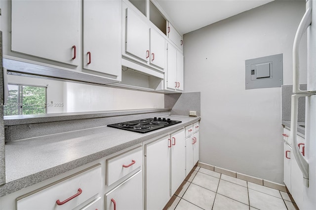 kitchen featuring black electric stovetop, white cabinetry, and light tile patterned floors