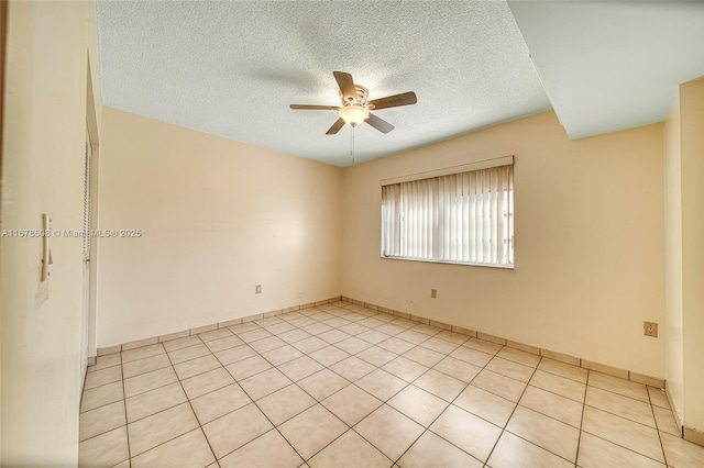 unfurnished room with light tile patterned flooring, a textured ceiling, and ceiling fan