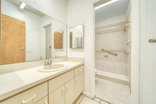 bathroom with toilet, tile patterned flooring, vanity, and walk in shower