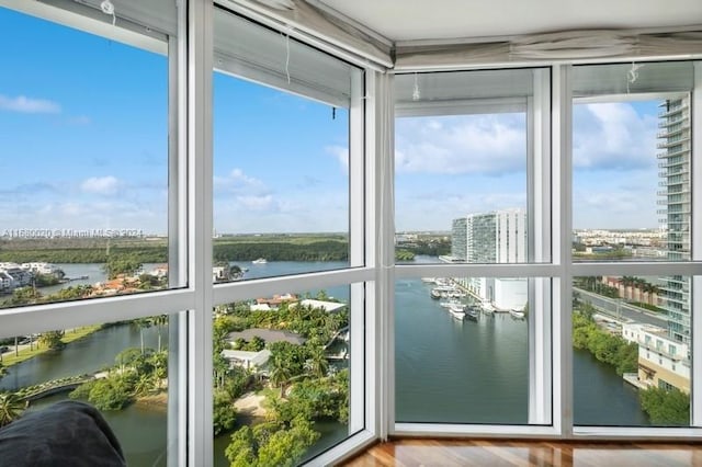 unfurnished sunroom featuring a water view