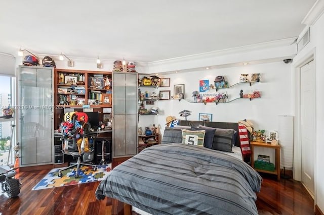 bedroom with dark hardwood / wood-style floors