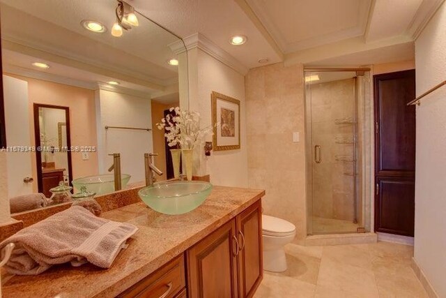 bathroom with vanity, an enclosed shower, crown molding, and toilet