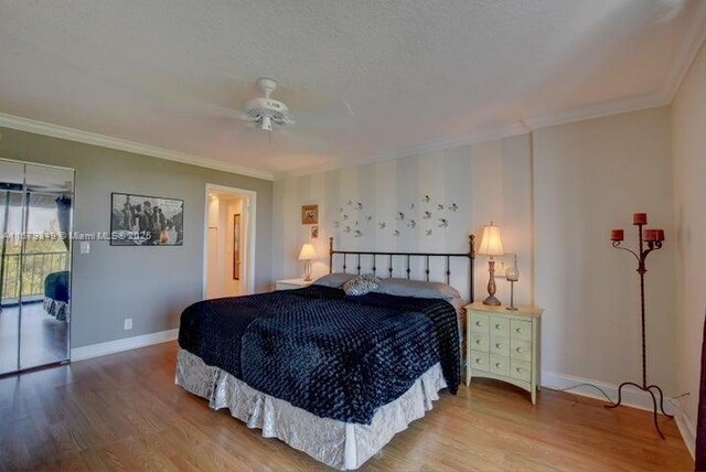 bedroom featuring wood-type flooring, ornamental molding, access to outside, and ceiling fan