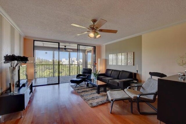 living room featuring floor to ceiling windows, hardwood / wood-style floors, a textured ceiling, and crown molding