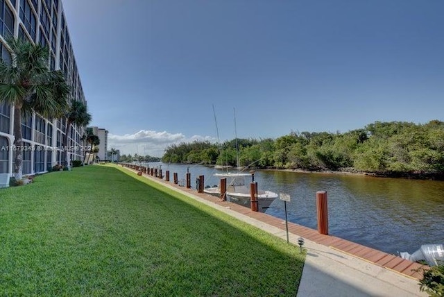 view of dock featuring a yard and a water view