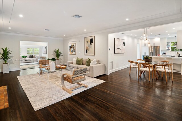 living room featuring crown molding and dark hardwood / wood-style floors