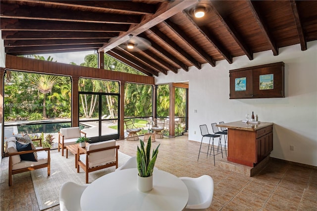 interior space featuring vaulted ceiling with beams and wood ceiling