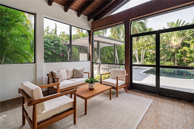 sunroom / solarium featuring lofted ceiling with beams and wooden ceiling