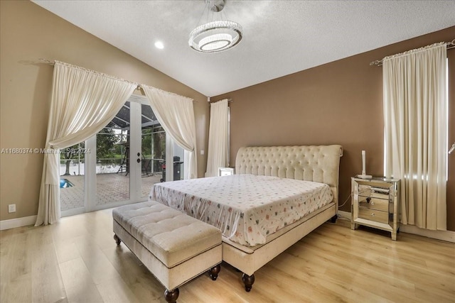 bedroom with vaulted ceiling, access to exterior, french doors, and wood-type flooring