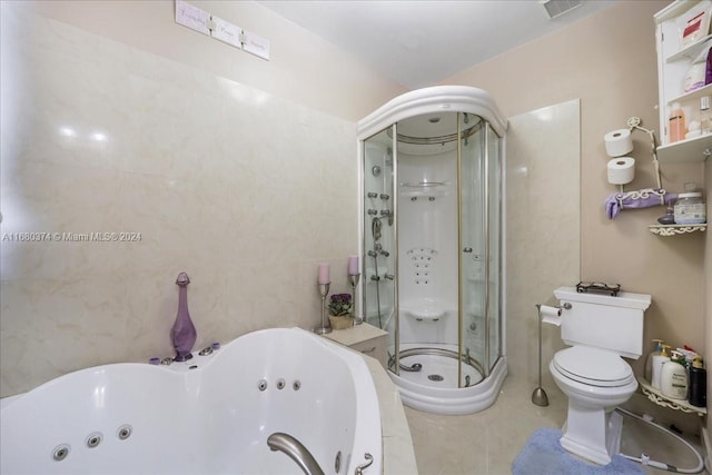 bathroom featuring toilet, tile walls, tile patterned floors, and independent shower and bath