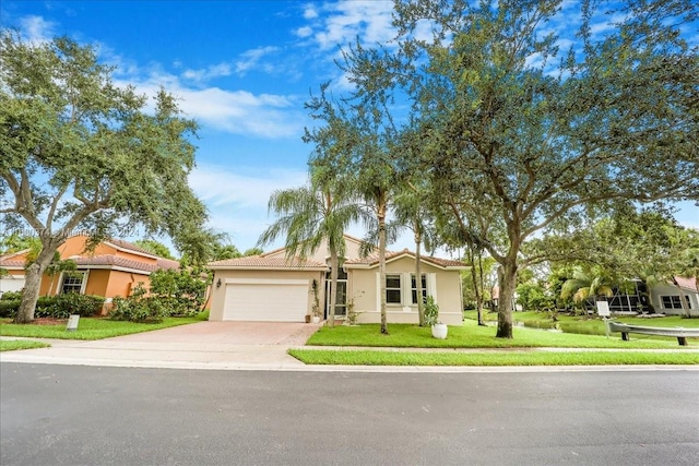 view of front of property with a front yard and a garage