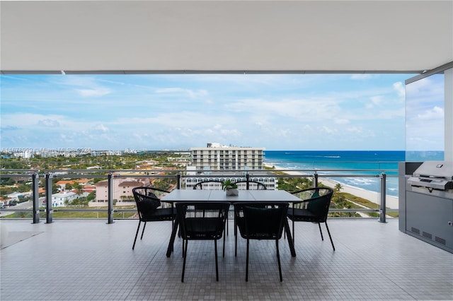 balcony with a water view and a view of the beach