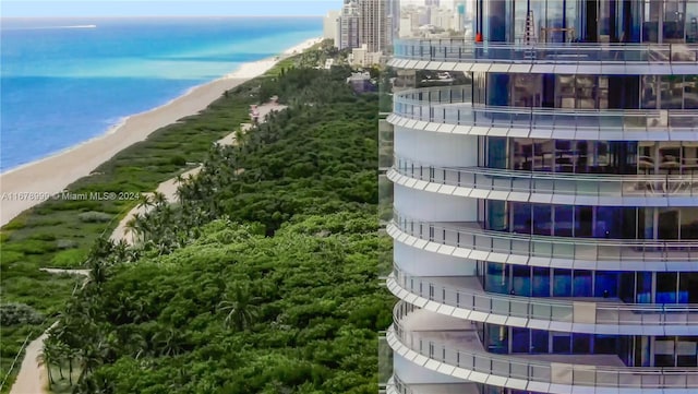 view of property featuring a water view and a beach view