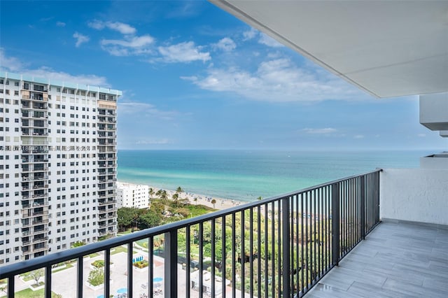 balcony with a water view and a beach view