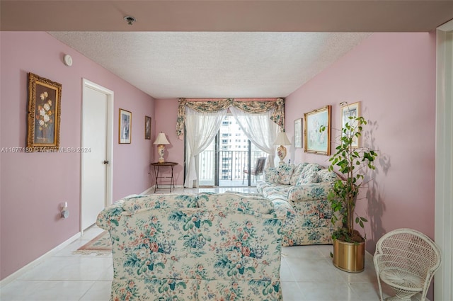 tiled bedroom featuring access to outside and a textured ceiling