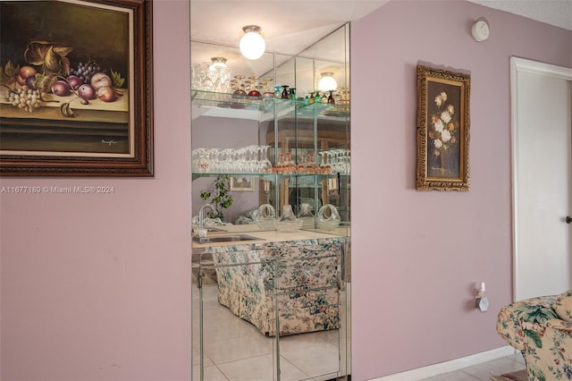 interior space with light tile patterned flooring and sink