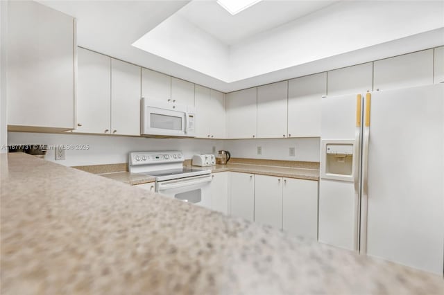 kitchen featuring white appliances, a toaster, white cabinetry, and light countertops