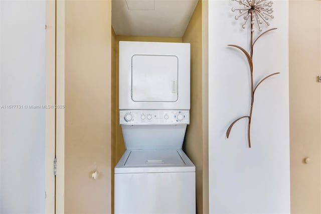 laundry area featuring stacked washer / dryer and laundry area