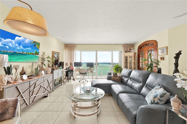 tiled living room featuring a textured ceiling