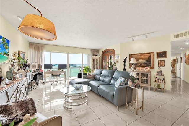 2451 Brickell Ave Unit 17G, Miami, FL 33129 - living area featuring light tile patterned flooring, track lighting, an office area, and a textured ceiling