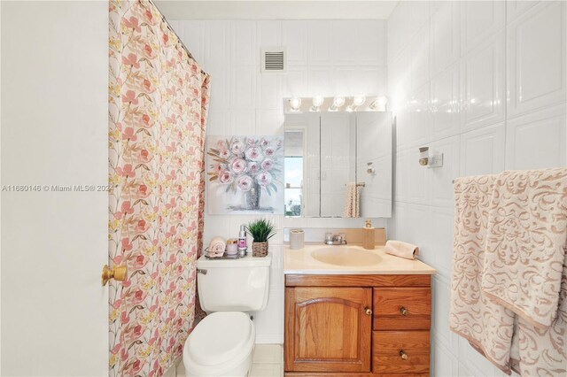 2451 Brickell Ave Unit 17G, Miami, FL 33129 - bathroom with vanity, toilet, and a shower with shower curtain