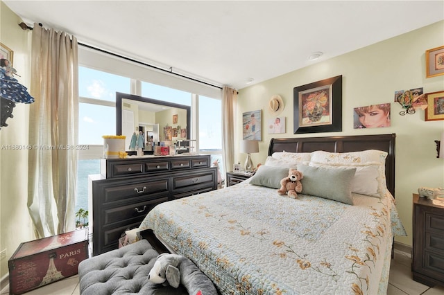 tiled bedroom with a water view