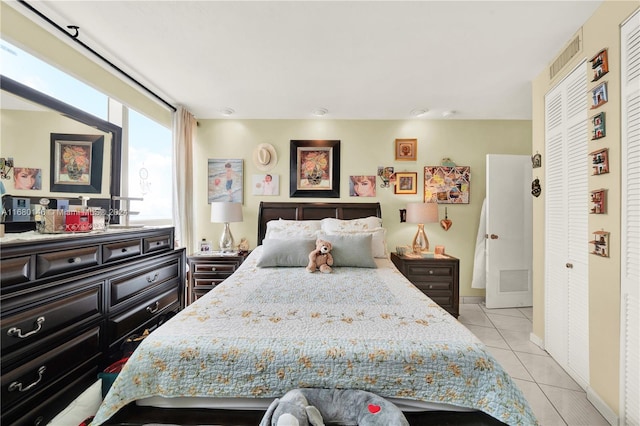 tiled bedroom with a closet