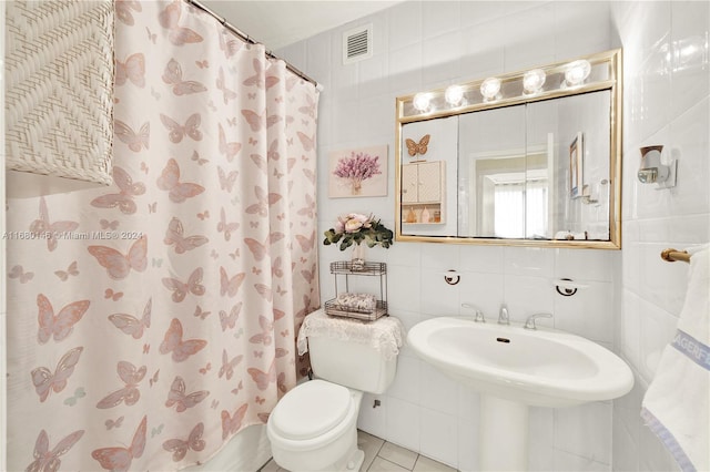 2451 Brickell Ave Unit 17G, Miami, FL 33129 - bathroom with toilet, tile walls, a shower with curtain, and tile patterned floors