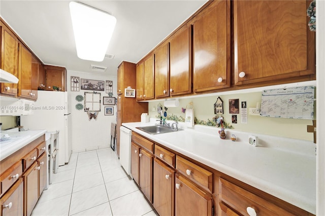 kitchen with ornamental molding, sink, light tile patterned flooring, and dishwasher