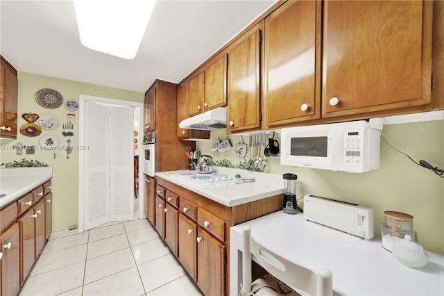 kitchen featuring white appliances and light tile patterned floors