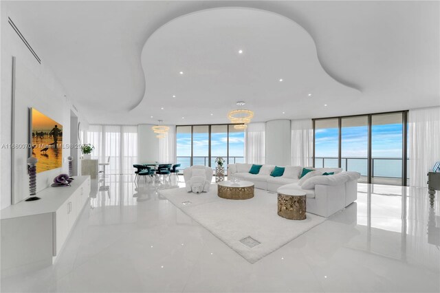 living room with floor to ceiling windows and a water view