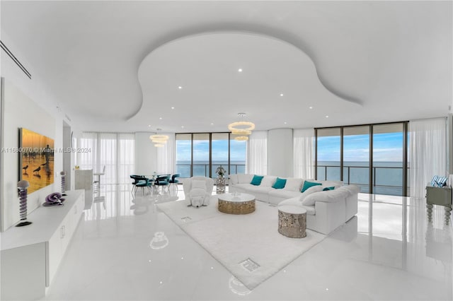 living room featuring a water view and expansive windows