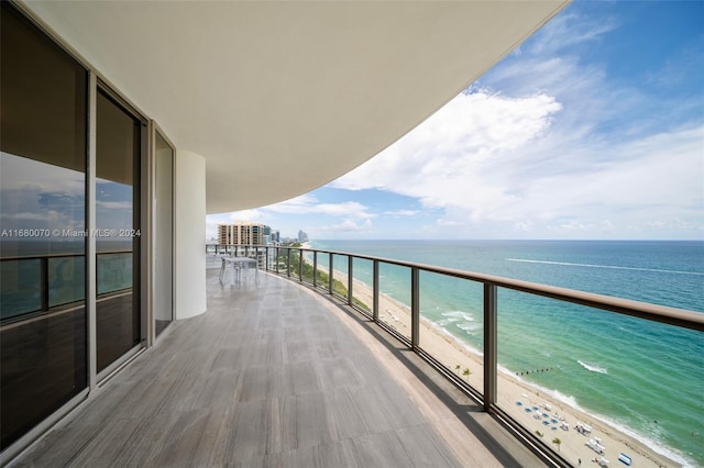 balcony with a view of the beach and a water view