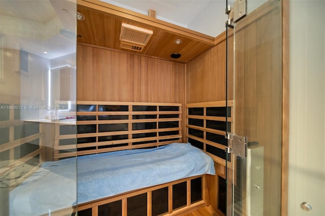 view of sauna / steam room with wooden walls, wooden ceiling, and wood-type flooring