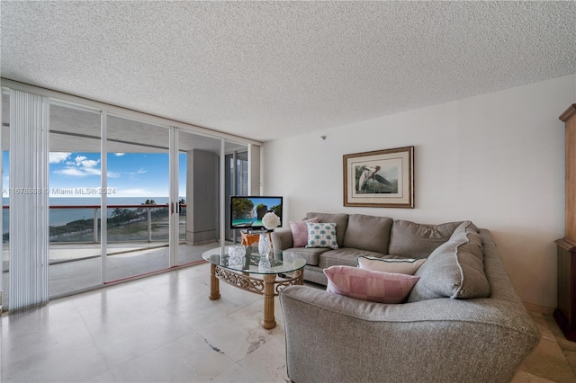 living room with expansive windows and a textured ceiling