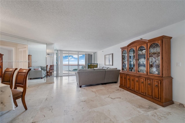 living room with expansive windows and a textured ceiling