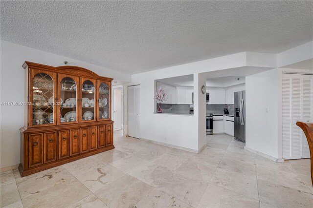 interior space featuring a textured ceiling