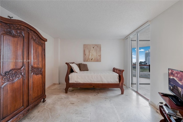 6767 Collins Ave Unit 602, Miami Beach, FL 33141 - bedroom featuring access to outside, a textured ceiling, and expansive windows