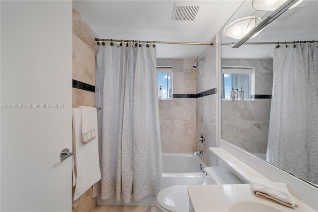 full bathroom with vanity, shower / bath combo with shower curtain, and toilet