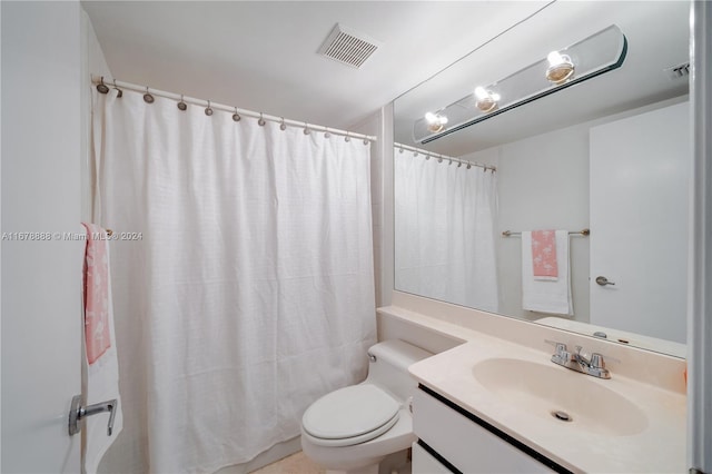 bathroom featuring vanity, a shower with curtain, and toilet