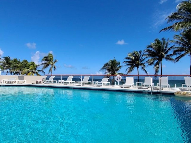 view of swimming pool with a water view