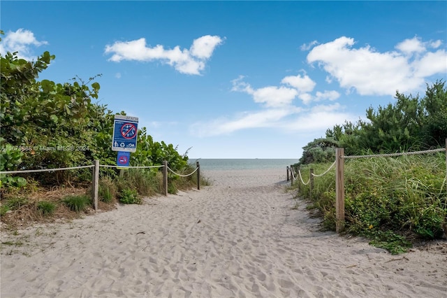 view of property's community featuring a view of the beach and a water view