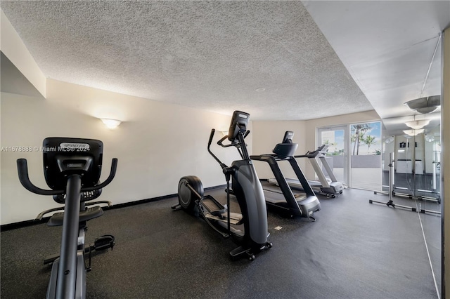6767 Collins Ave Unit 602, Miami Beach, FL 33141 - exercise room featuring a textured ceiling and baseboards