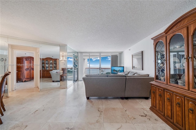 living room featuring expansive windows and a textured ceiling