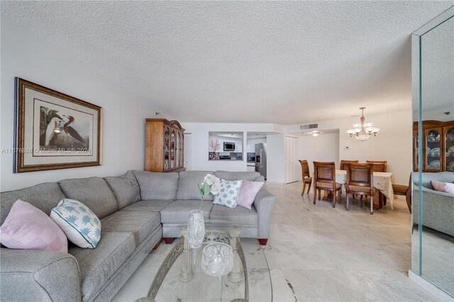 6767 Collins Ave Unit 602, Miami Beach, FL 33141 - living room with a chandelier and a textured ceiling