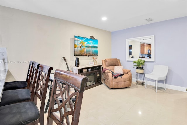 interior space with light tile patterned floors and a fireplace