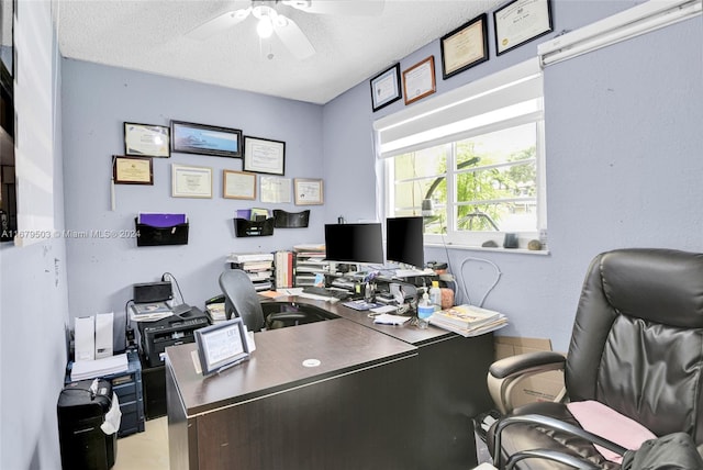 office area with ceiling fan and a textured ceiling